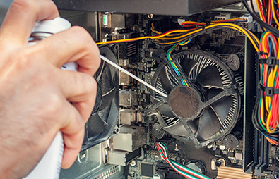 using a can of compressed air to clean the inside of a PC using a can of compressed air to clean the inside of a PC