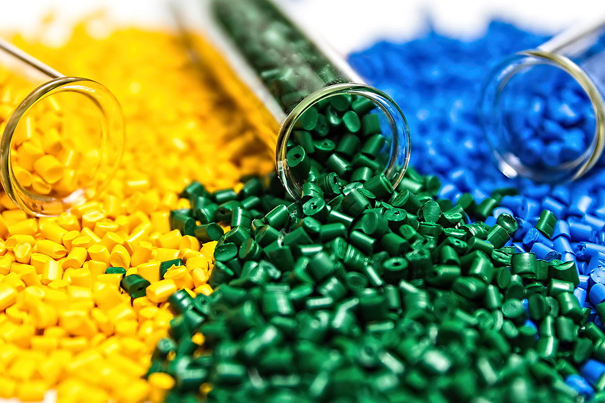 a collection of yellow, green, and blue plastic granules poured out together.