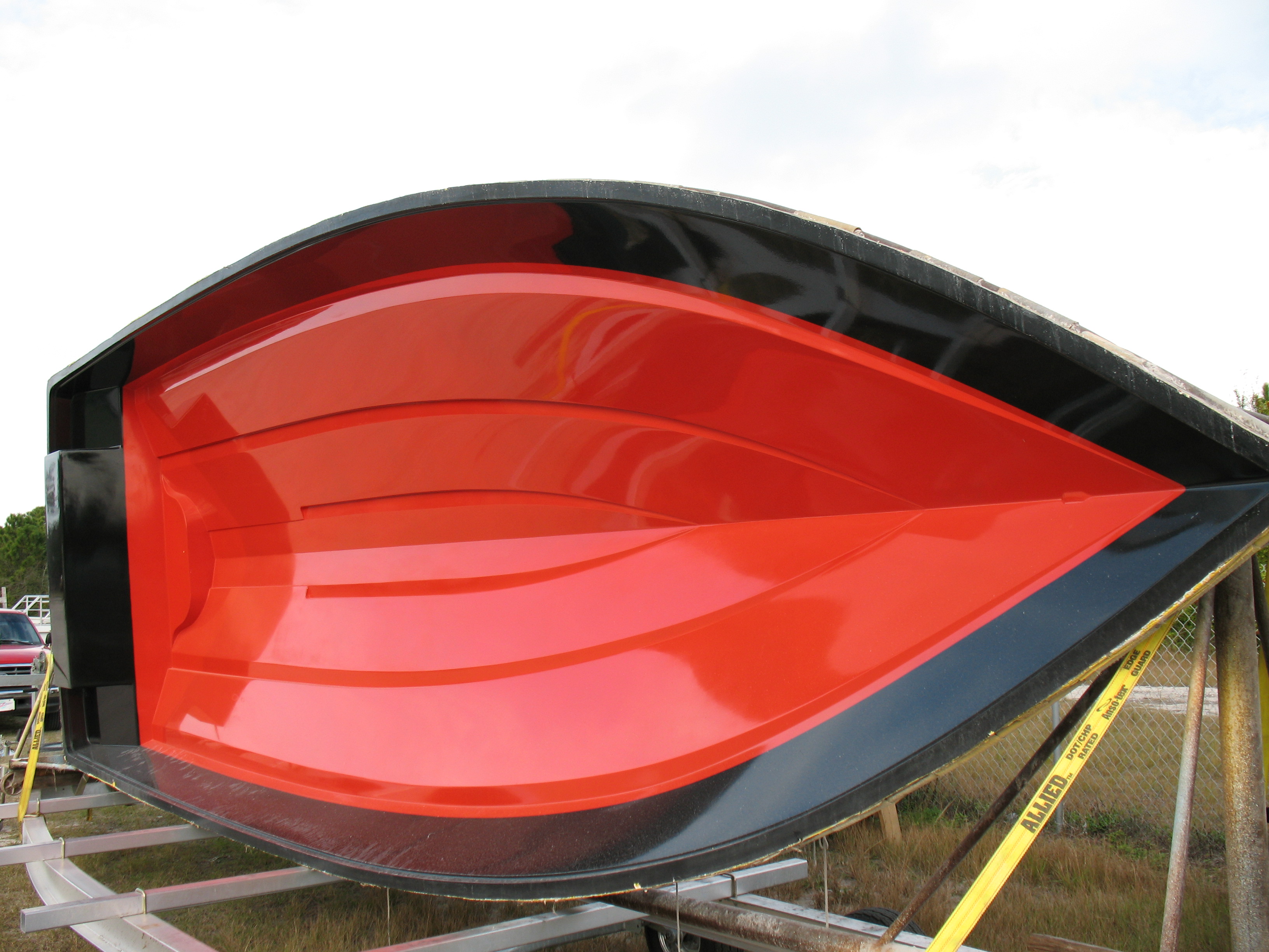 The mold for a boat hull arrives at a production facility.