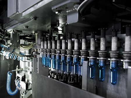 Plastic bottles on a blow-molding machine.